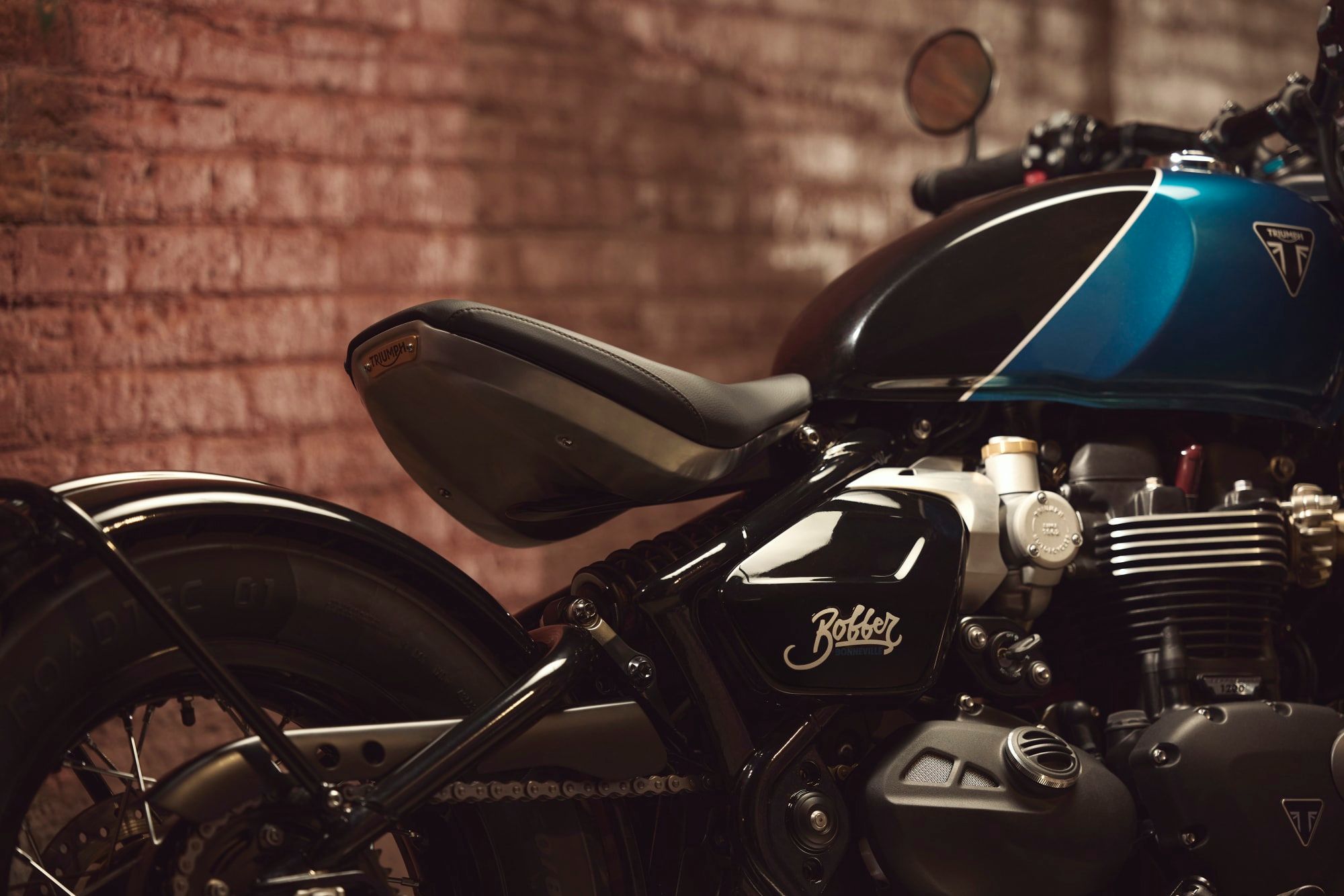 The 2026 Bonneville Bobber's new tank and wider seat, in Interstellar Blue