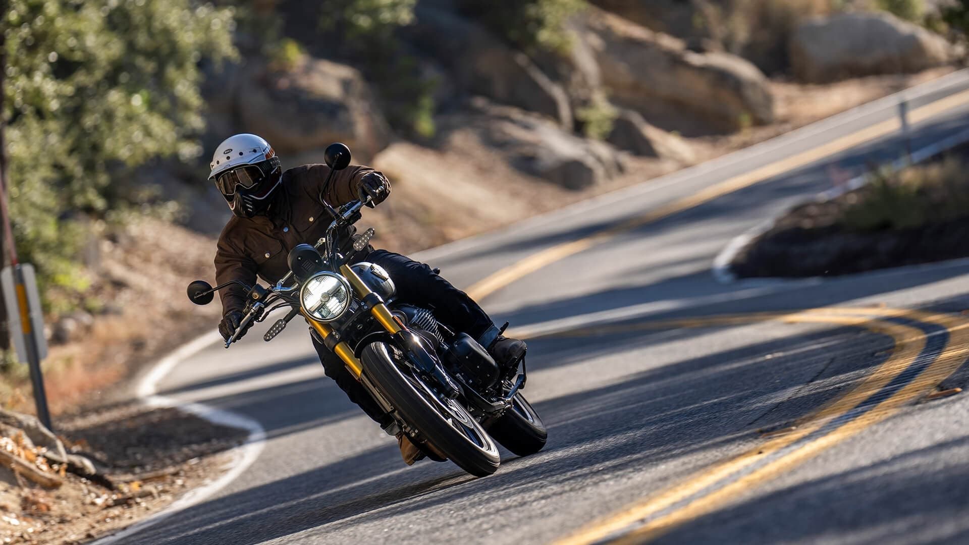 A Bear 650 leaning into a hillside bend, photographed by Royal Enfield